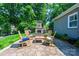 Stone patio with cozy seating and stone fireplace, perfect for outdoor entertaining at 2024 5Th Street Nw Pl, Hickory, NC 28601