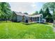 Expansive backyard featuring a stone fireplace, screened porch, and lush lawn perfect for outdoor activities at 2024 5Th Street Nw Pl, Hickory, NC 28601