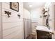 Cozy bathroom with shiplap walls, stylish fixtures, and a shower with curtain at 2024 5Th Street Nw Pl, Hickory, NC 28601