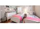 Comfortable bedroom with two twin beds, dresser, and stylish decor at 2024 5Th Street Nw Pl, Hickory, NC 28601