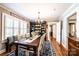 Elegant dining room with a large wooden table, decorative hutch, and natural light at 2024 5Th Street Nw Pl, Hickory, NC 28601