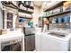 Efficient laundry room featuring white appliances, brick walls and lots of storage shelves at 2024 5Th Street Nw Pl, Hickory, NC 28601