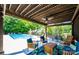 Outdoor patio featuring comfortable seating, dining area, and a view of the sparkling pool and landscaped backyard at 2024 5Th Street Nw Pl, Hickory, NC 28601