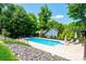 Inviting in-ground pool with lounge chairs for relaxation, surrounded by lush greenery and fencing at 2024 5Th Street Nw Pl, Hickory, NC 28601
