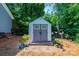 Well maintained shed with double doors, plants, and brick paver entry in a wooded area at 2024 5Th Street Nw Pl, Hickory, NC 28601