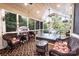 Enclosed sunroom featuring wicker furniture, a ceiling fan, and a view of the outdoors at 2024 5Th Street Nw Pl, Hickory, NC 28601