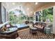 Bright sunroom offers multiple seating areas, large windows, and a hot tub at 2024 5Th Street Nw Pl, Hickory, NC 28601