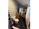 Bathroom with black tile, toilet, and shelving at 208 S Ransom St, Gastonia, NC 28052