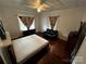 Bright bedroom with hardwood floors, ceiling fan, and classic window treatments at 208 S Ransom St, Gastonia, NC 28052