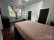 Spacious bedroom with hardwood floors, bright window and modern paneled walls at 208 S Ransom St, Gastonia, NC 28052