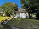 Charming home featuring a covered porch, brick chimney, and landscaped front yard at 208 S Ransom St, Gastonia, NC 28052