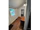 Hallway with window, light, and view into the bathroom at 208 S Ransom St, Gastonia, NC 28052