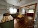 Sunlit kitchen featuring modern appliances, butcher block countertops, a dining area and hardwood floors at 208 S Ransom St, Gastonia, NC 28052