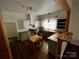 Well-lit kitchen with wooden countertops, updated cabinets, stainless steel appliances, and a dining area at 208 S Ransom St, Gastonia, NC 28052