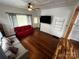 Inviting living room featuring hardwood floors, white paneled walls and plenty of natural light at 208 S Ransom St, Gastonia, NC 28052