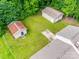 Birds-eye view of the home and property with lush greenery and outbuildings at 2111 Parkdale Ave, Gastonia, NC 28052