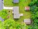 Overhead view of the property showcasing the house, yard, sheds, and surrounding trees at 2111 Parkdale Ave, Gastonia, NC 28052