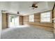 Large basement room with brick walls, drop ceiling, and sliding glass door to the backyard at 2111 Parkdale Ave, Gastonia, NC 28052
