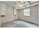 Basement with white painted brick and paneled walls, drop ceiling, and window at 2111 Parkdale Ave, Gastonia, NC 28052