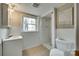 Bright bathroom features tiled floor, vanity, and shower with white accents at 2111 Parkdale Ave, Gastonia, NC 28052