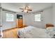 Bedroom featuring hardwood floors, a ceiling fan, two windows, and a bed with floral bedding at 2111 Parkdale Ave, Gastonia, NC 28052