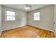 Bedroom featuring hardwood floors, two windows providing natural light, and neutral decor at 2111 Parkdale Ave, Gastonia, NC 28052