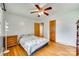 Bedroom featuring hardwood floors, a ceiling fan, a window, and a bed with a floral bedspread at 2111 Parkdale Ave, Gastonia, NC 28052