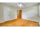 Bedroom featuring hardwood floors, a ceiling fan, and closet; well-lit and spacious at 2111 Parkdale Ave, Gastonia, NC 28052