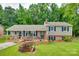 Charming split-level home with large front yard, brick accents, blue shutters and spacious deck for outdoor enjoyment at 2111 Parkdale Ave, Gastonia, NC 28052