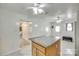 Kitchen area featuring a central granite island, white tile floors, and ample lighting for food preparation at 2111 Parkdale Ave, Gastonia, NC 28052