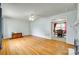 Bright living room with hardwood floors, ceiling fan, and view into the dining area at 2111 Parkdale Ave, Gastonia, NC 28052