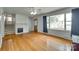 Bright living room featuring hardwood floors, fireplace, and large window with natural light at 2111 Parkdale Ave, Gastonia, NC 28052