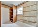 Basement storage space with brick walls, shelving, and a window at 2111 Parkdale Ave, Gastonia, NC 28052