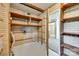 Basement storage area with brick walls, open shelves, and utility access at 2111 Parkdale Ave, Gastonia, NC 28052