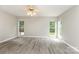 Spacious bedroom with wood floors, neutral walls, two windows, and a ceiling fan at 270 Kilmer Ln, Mooresville, NC 28115