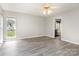 Light-filled bedroom with wood floors, white walls, ceiling fan, and ensuite bathroom at 270 Kilmer Ln, Mooresville, NC 28115