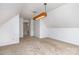 Spacious bonus room with neutral walls, plush carpeting, and a contemporary light fixture, creating a versatile space at 270 Kilmer Ln, Mooresville, NC 28115