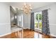 Dining room with hardwood floors, decorative chandelier, and large window with patterned drapes at 270 Kilmer Ln, Mooresville, NC 28115