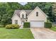 Charming yellow home featuring an attached garage and a beautifully landscaped front yard at 270 Kilmer Ln, Mooresville, NC 28115