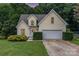 Charming yellow home featuring an attached garage and a beautifully landscaped front yard at 270 Kilmer Ln, Mooresville, NC 28115