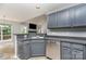 Galley kitchen featuring gray cabinets, stainless steel appliances, and tile flooring at 270 Kilmer Ln, Mooresville, NC 28115
