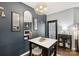 Chic dining area with modern light fixture, table with marble top, and dark accent wall at 344 Kennebel Pl, Fort Mill, SC 29715