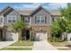 Charming townhome showcasing a brick and shake facade, complemented by a one-car garage and professionally landscaped front yard at 344 Kennebel Pl, Fort Mill, SC 29715