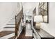 Elegant foyer featuring hardwood floors, a staircase with wood and wrought iron, and stylish console table decor at 344 Kennebel Pl, Fort Mill, SC 29715