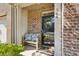 Inviting front porch with a bench, brick accents, 'Welcome' wreath, and a 'Hello' door mat creating a cozy entrance at 344 Kennebel Pl, Fort Mill, SC 29715