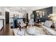 Stylish living room with modern furnishings, hardwood floors, and an open-concept kitchen at 344 Kennebel Pl, Fort Mill, SC 29715