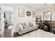 Bright living room featuring modern art, a gray sofa, and a decorative rug at 344 Kennebel Pl, Fort Mill, SC 29715