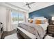 Serene main bedroom showcasing a tray ceiling, large window, and accent wall at 344 Kennebel Pl, Fort Mill, SC 29715