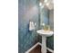 Elegant powder room featuring designer wallpaper, pedestal sink, and gold fixtures at 344 Kennebel Pl, Fort Mill, SC 29715