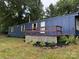 The side of a blue manufactured home with a small porch at 41042 Dennis Rd, Albemarle, NC 28001